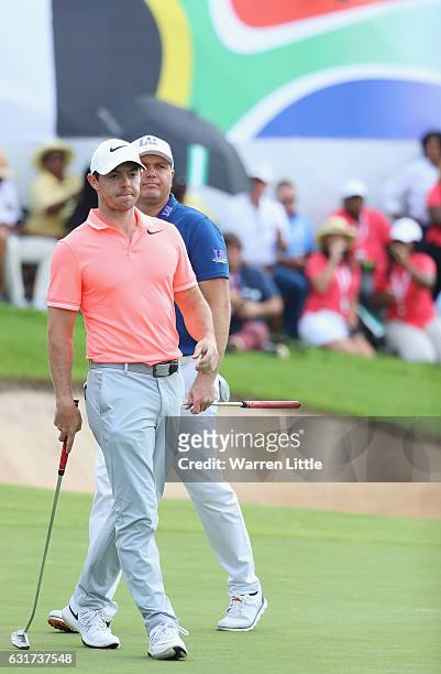Graeme Storm of England and Rory McIlroy of Northern Ireland look on from the18th green during the final round of the BMW South African Open...