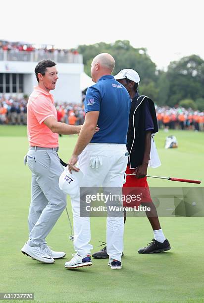 Rory McIlroy of Northern Ireland congratulates Graeme Storm of England after victory in the third extra play off hole during the final round of the...