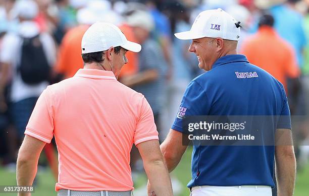 Rory McIlroy of Northern Ireland and Graeme Storm of England walk off the 18th green after the second play off hole during the final round of the BMW...