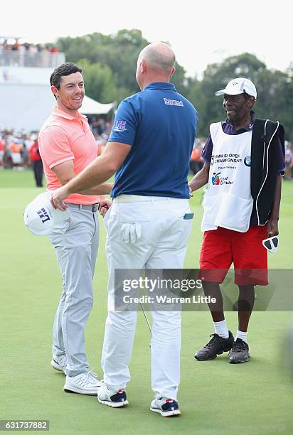 Rory McIlroy of Northern Ireland congratulates Graeme Storm of England after victory in the third extra play off hole during the final round of the...