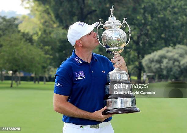 Graeme Storm of England poses with the trophy after his play-off win in the final round of the 2017 BMW South African Open Championship at Glendower...