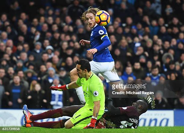 Tom Davies of Everton lifts the ball over goalkeeper Claudio Bravo of Manchester City to score his team's third goal during the Premier League match...