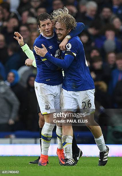 Everton's English midfielder Tom Davies celebrates with Everton's English midfielder Ross Barkley after scoring their third goal during the English...