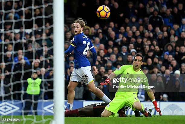 Tom Davies of Everton lifts the ball over goalkeeper Claudio Bravo of Manchester City to score his team's third goal during the Premier League match...