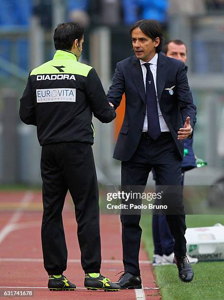 Lazio head coach Simone Inzaghi shakes the hand with the fourth referee Gianluca Vuoto after receiving the red card during the Serie A match between...