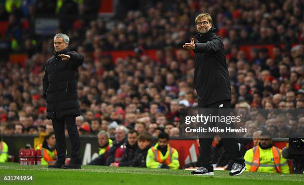 Jurgen Klopp manager of Liverpool and Jose Mourinho manager of Manchester United give instructions during the Premier League match between Manchester...