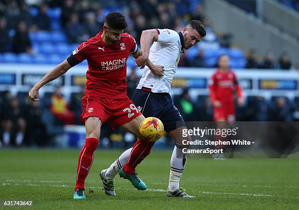Bolton Wanderers' Gary Madine battles with Swindon Town's Raphael Rossi Branco during the Sky Bet League One match between Bolton Wanderers and...