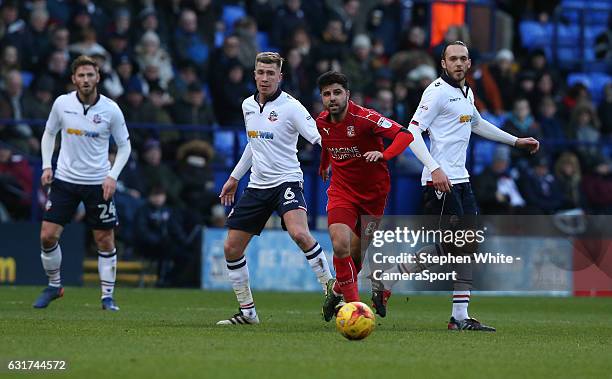 Swindon Town's Yaser Kasim gets away from Bolton Wanderers' Josh Vela and Tom Thorpe during the Sky Bet League One match between Bolton Wanderers and...