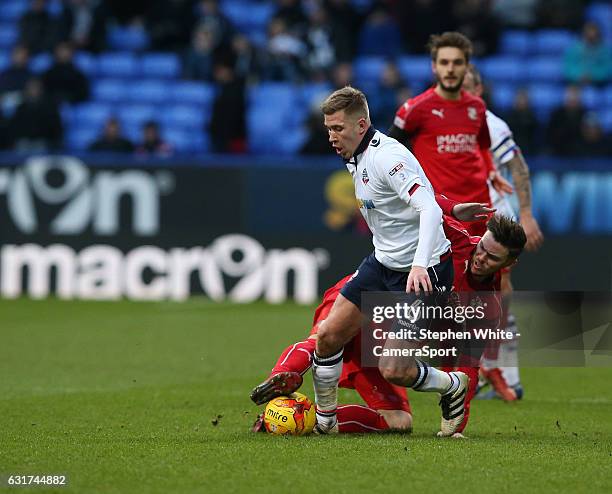 Bolton Wanderers' Josh Vela is tackled by Swindon Town's Ben Gladwin during the Sky Bet League One match between Bolton Wanderers and Swindon Town at...