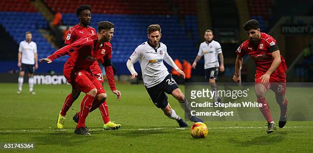 Bolton Wanderers' James Henry flanked by Swindon Town's Ben Gladwin and Yaser Kasim during the Sky Bet League One match between Bolton Wanderers and...