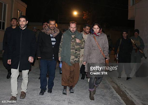Spanish Red Cross employee Juan Carlos is escorted by Afghan security personnel, following his release after being abducted, in Kunduz on January 15,...