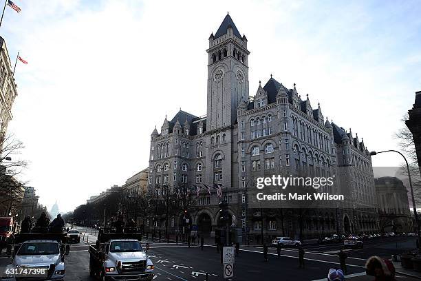 Vehicles participating in an inaugural parade rehearsal pass by the Trump Internationa Hotel, January 15, 2017 in Washington, DC. On January 20...