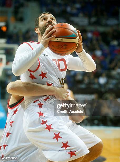 Vladimir Stimac helps Arda Turan to score basket during Spor Toto All - Star 2017 match between the Europe and Asia teams at Ulker Sports Arena in...