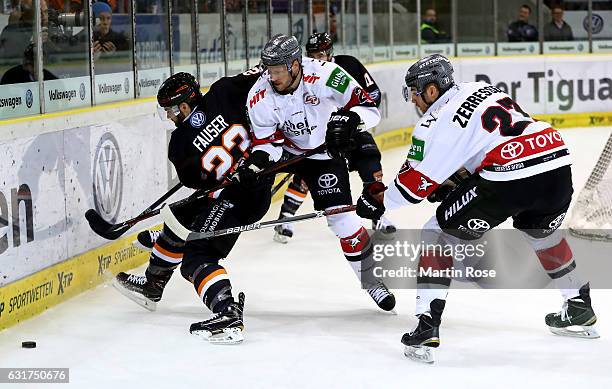 Gerrit Fauser of Wolfsburg and Corey Potter of Koeln battle for the puck during the DEL match between Grizzly Wolfsburg and Koelner Haie at BraWo Ice...