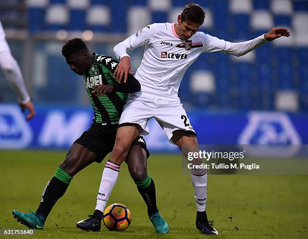 Alfred Duncan of Sassuolo and Norbert Balogh of Palermo compete for the ball during the Serie A match between US Sassuolo and US Citta di Palermo at...