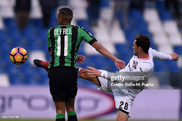 Gregoire Defrel of Sassuolo and Mato Jajalo of Palermo compete for the ball during the Serie A match between US Sassuolo and US Citta di Palermo at...