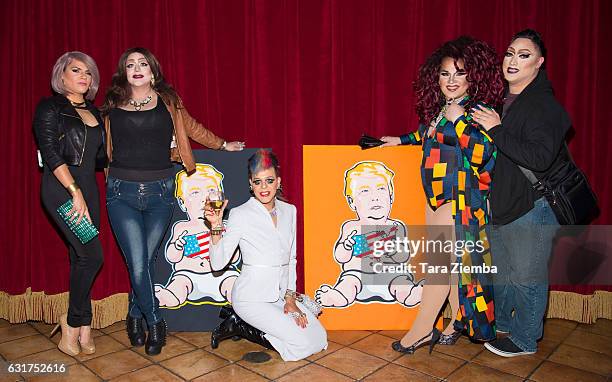 Personality/Pop artist Sham Ibrahim poses for a photo with guests during his unveiling of a Donald Trump portrait at Oscar's on January 14, 2017 in...