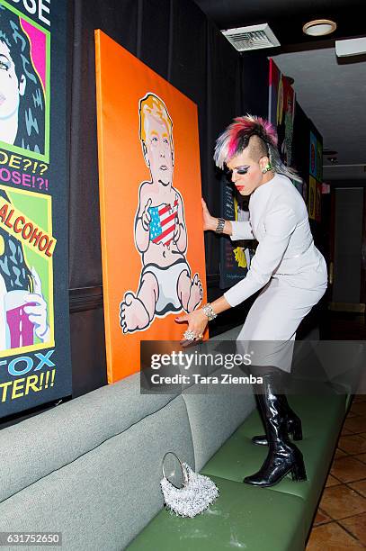 Personality/Pop artist Sham Ibrahim sets up his portrait of Donald Trump at Oscar's on January 14, 2017 in Palm Springs, California.