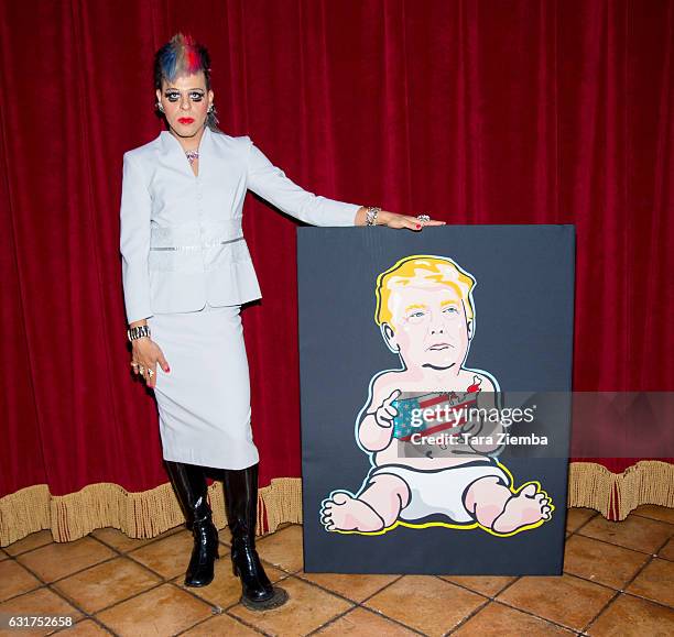 Personality/Pop artist Sham Ibrahim poses for a photo with his portrait of a Donald Trump at Oscar's on January 14, 2017 in Palm Springs, California.