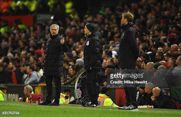 Jose Mourinho manager of Manchester United reacts towards fourth official Craig Pawson as Jurgen Klopp manager of Liverpool looks on during the...