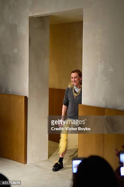 Designer Miuccia Prada acknowledges the applause of the audience at the Prada show during Milan Men's Fashion Week Fall/Winter 2017/18 on January 15,...