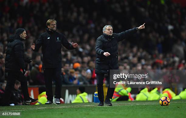 Jose Mourinho manager of Manchester United and Jurgen Klopp manager of Liverpool react during the Premier League match between Manchester United and...