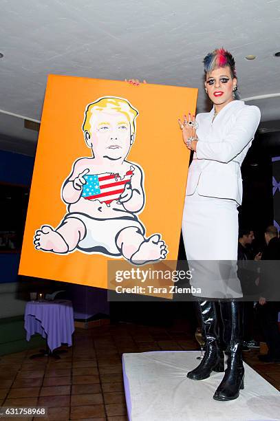 Personality/Pop artist Sham Ibrahim poses for a photo with his portrait of Donald Trump at Oscar's on January 14, 2017 in Palm Springs, California.