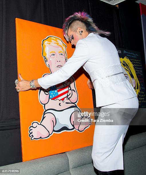 Personality/Pop artist Sham Ibrahim sets up his portrait of Donald Trump at Oscar's on January 14, 2017 in Palm Springs, California.