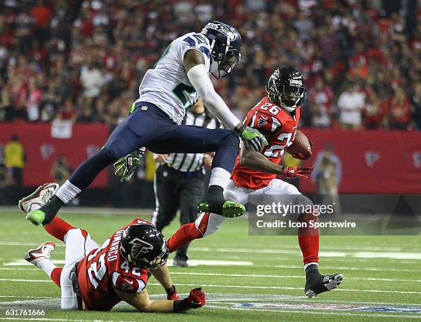 Seattle Seahawks defensive back Neiko Thorpe leaps overAtlanta Falcons fullback Patrick DiMarco to tackle Atlanta Falcons running back Tevin Coleman...