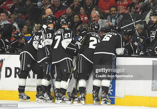 Kings head coach Darryl Sutter talks with the team during a stoppage in play during an NHL game between the Detroit Red Wings and the Los Angeles...