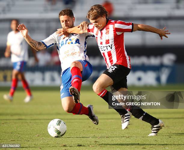 Sebastian Durbabier of Argentine club Estudiantes de la Plata is tackled by Jose Vivian of Brazilian club Bahia during their Florida Cup soccer game...