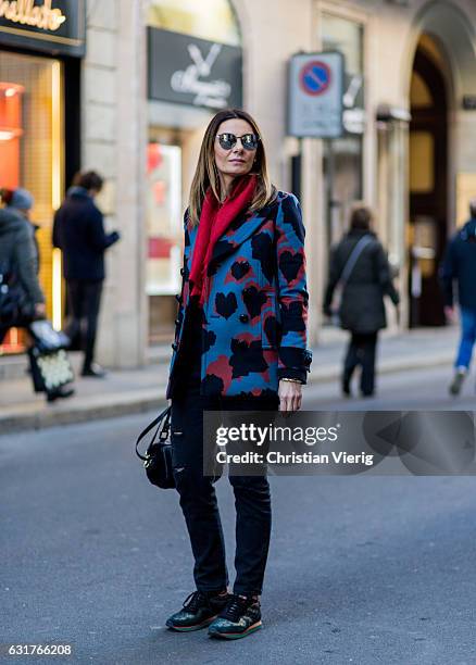 Anastasya Lanchava is wearing a coat, Etro sneaker, Gucci scarf during Milan Men's Fashion Week Fall/Winter 2017/18 on January 15, 2017 in Milan,...