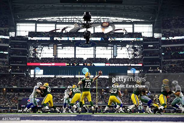 Aaron Rodgers of the Green Bay Packers throws a pass in the first half during the NFC Divisional Playoff Game against the Dallas Cowboys at AT&T...