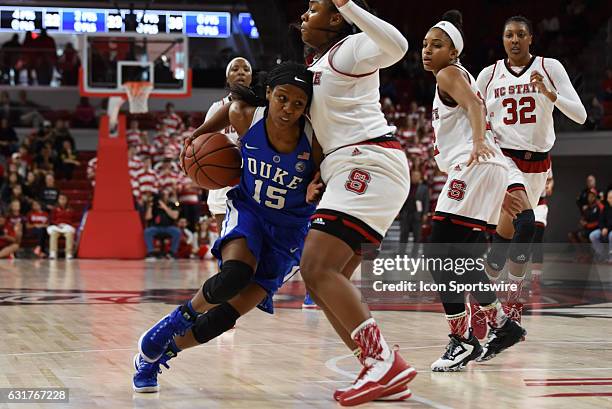 Duke Blue Devils guard Kyra Lambert drives into North Carolina State Wolfpack guard Camille Anderson during a game between the Duke Blue Devils and...