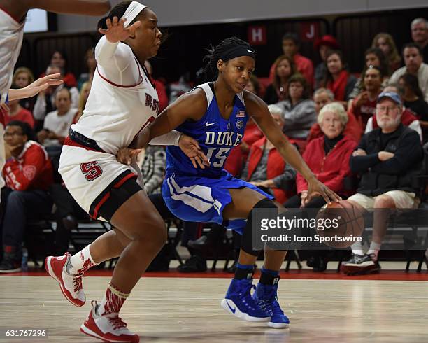 Duke Blue Devils guard Kyra Lambert drives by North Carolina State Wolfpack guard Camille Anderson during a game between the Duke Blue Devils and the...