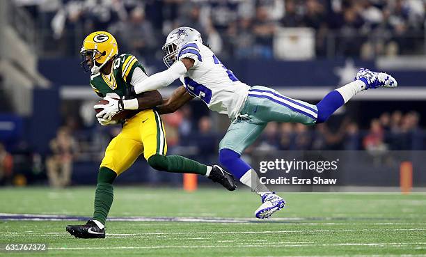 Brandon Carr of the Dallas Cowboys attempts to tackle Geronimo Allison of the Green Bay Packers in the first half during the NFC Divisional Playoff...