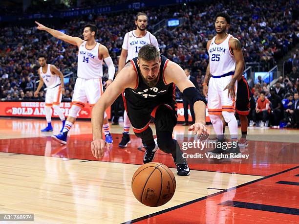 Jonas Valanciunas of the Toronto Raptors dives for the ball during the second half of an NBA game against the New York Knicks at Air Canada Centre on...