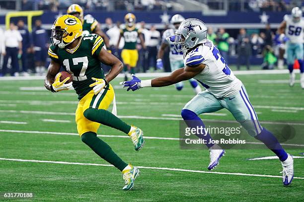Davante Adams of the Green Bay Packers runs with the ball while being pursued by Byron Jones of the Dallas Cowboys in the first half during the NFC...