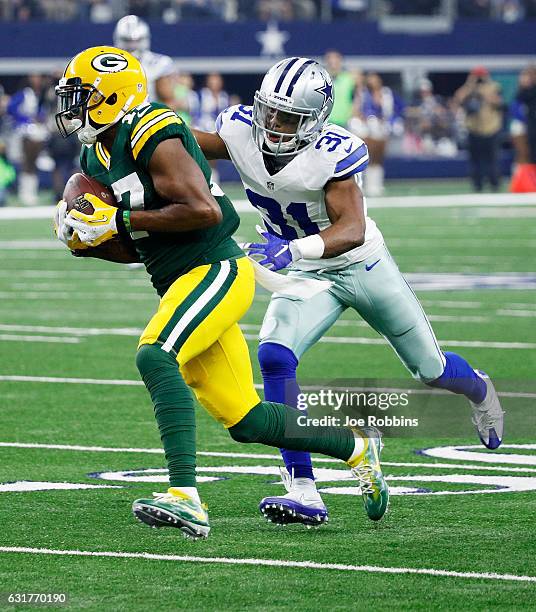 Davante Adams of the Green Bay Packers runs with the ball while being pursued by Byron Jones of the Dallas Cowboys in the first half during the NFC...