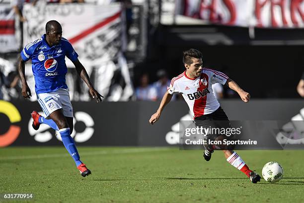 River Plate defender Luis Olivera dribbles away from Millonarios defender Anier Alfonso Figueroa Mosquera during the second half of a Florida Cup...