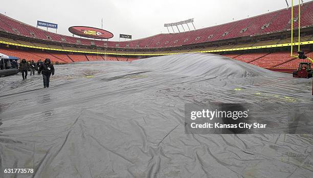 The Arrowhead Stadium field is covered to protect it from the ice and rain before the AFC Divisional Playoff game between the Kansas City Chiefs and...