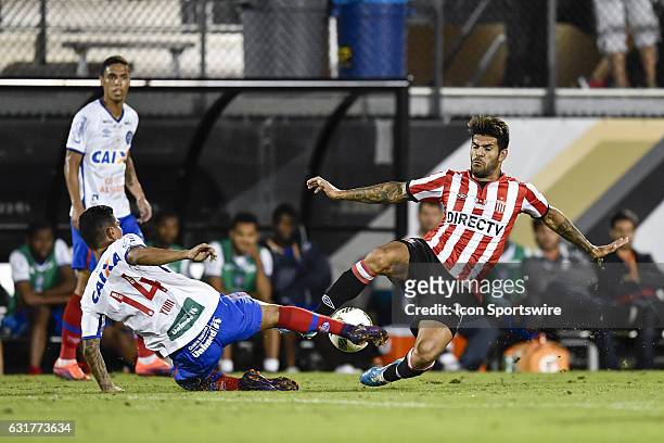Estudiantes forward Javier Toledo and Bahia midfielder Yuri Lara tackle the ball during the second half of the Florida Cup game between Bahia and...