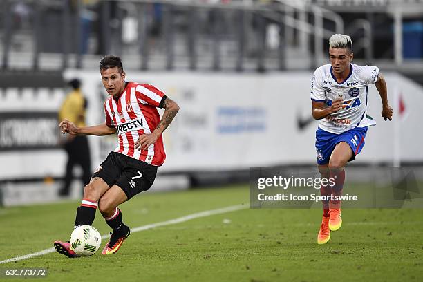 Estudiantes forward Carlos Auzqui plays the ball up field and away from Bahia midfielder Paulo Junior during the first half of the Florida Cup game...