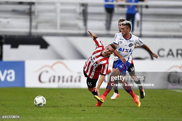 Estudiantes midfielder Bautista Cejas is fouled by Bahia midfielder Paulo Junior during the first half of the Florida Cup game between Bahia and...