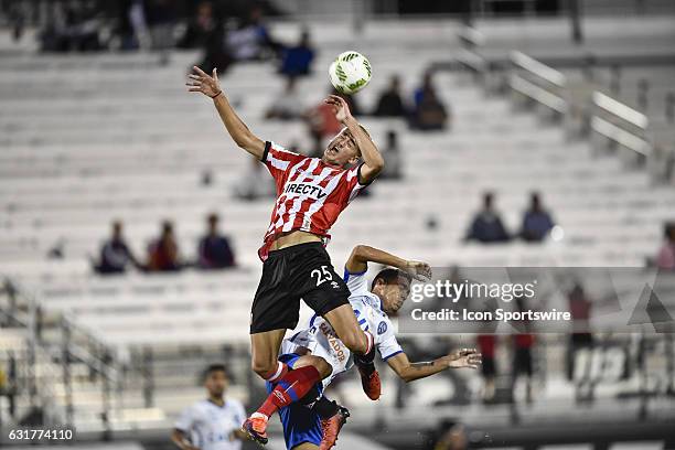 Estudiantes forward Ignacio Bailone wins a header while defended by Bahia defender Eder Graminho during the second half of the Florida Cup game...