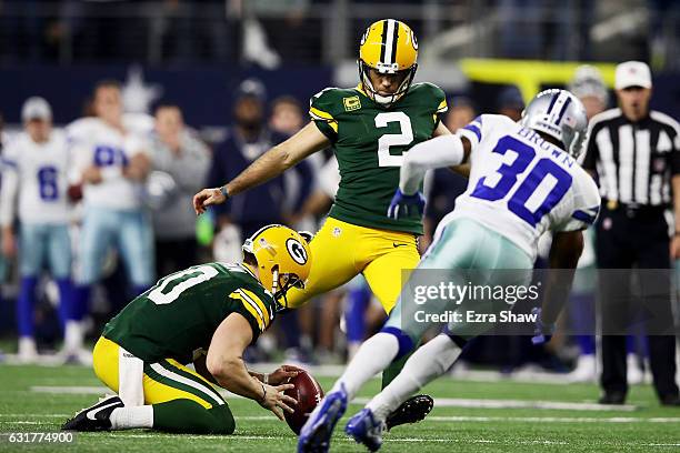 Mason Crosby of the Green Bay Packers kicks a field goal to beat the Dallas Cowboys 34-31 in the NFC Divisional Playoff Game at AT&T Stadium on...