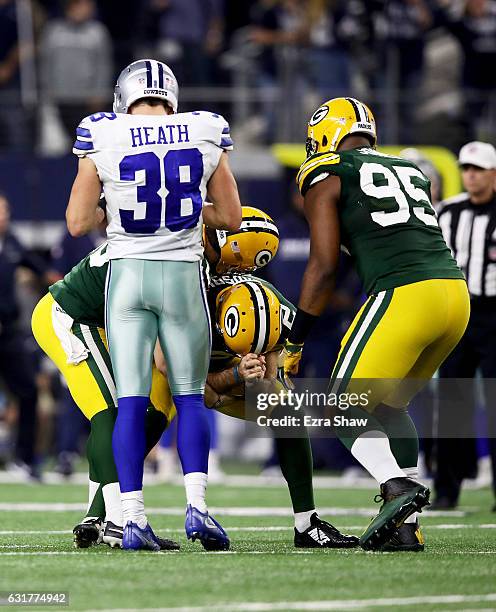 Mason Crosby of the Green Bay Packers reacts after kicking a field goal to beat the Dallas Cowboys 34-31 in the NFC Divisional Playoff Game at AT&T...