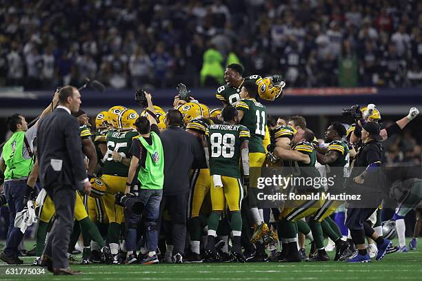 The Green Bay Packers celebrate after the game-winning field goal by Mason Crosby against the Dallas Cowboys in the NFC Divisional Playoff game at...