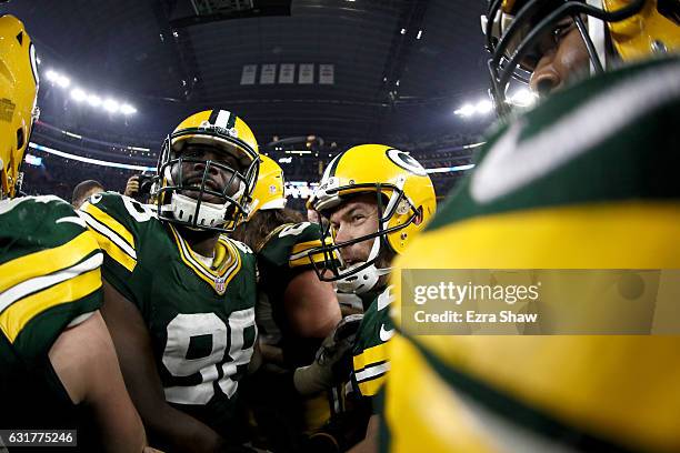 Mason Crosby of the Green Bay Packers is congratulated by teammates after he kicked a last second field goal to defeat the Dallas Cowboys in the NFC...