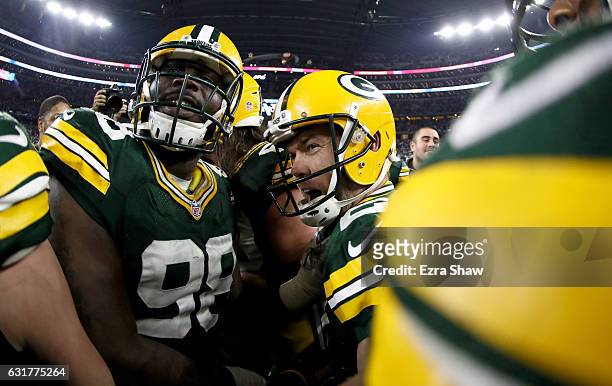Mason Crosby of the Green Bay Packers is congratulated by teammates after he kicked a last second field goal to defeat the Dallas Cowboys in the NFC...